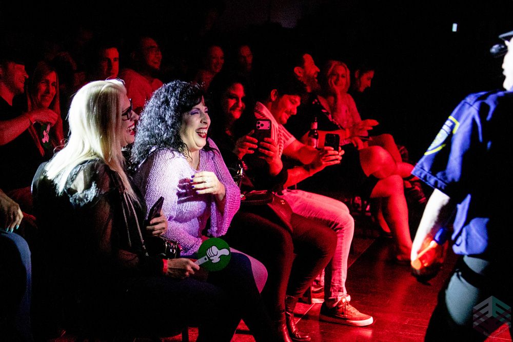 Audience members laughing in the front row