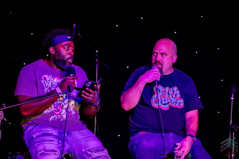Two comedians on mics