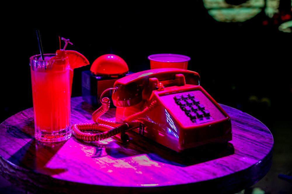 The red phone and a cocktail on the stage table