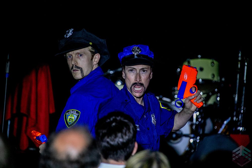 Two mustached cops with toy blasters